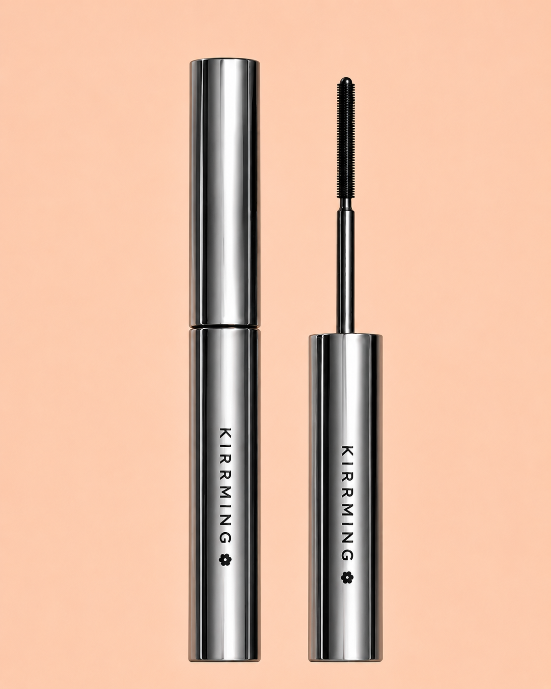 KIRRMING mascara shown in two silver tubes on a solid peach background, with one tube open to reveal the black mascara wand.