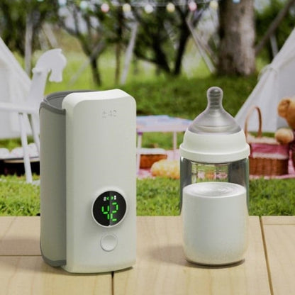 Portable Baby Bottle Warmer – USB rechargeable milk heating bag next to a baby bottle outdoors.