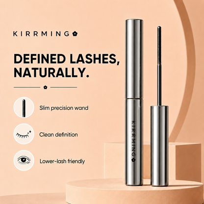 KIRRMING mascara shown in a clean studio-style ad with the closed silver tube and the wand applicator beside it. Text on the left reads 'KIRRMING' and 'DEFINED LASHES, NATURALLY.