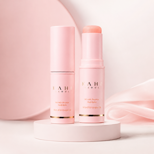 KAHI Wrinkle Bounce Multi Balm shown open and closed on a soft pink pedestal with clean premium skincare styling.