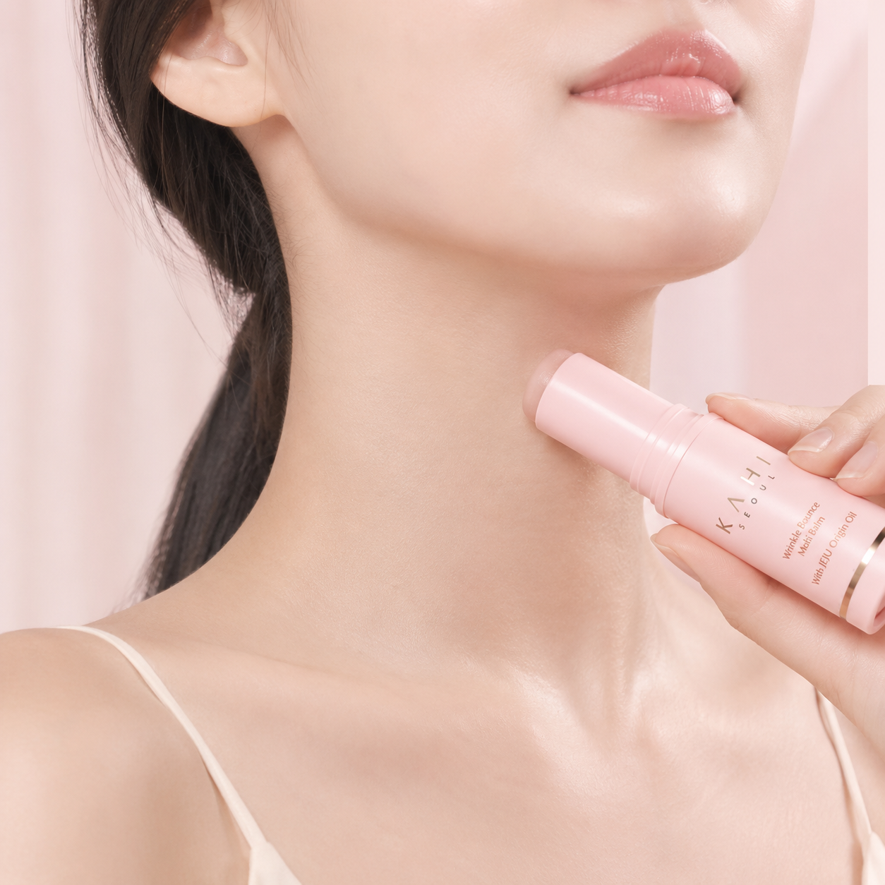 Person applying KAHI Wrinkle Bounce Multi Balm to the neck as part of a daily skincare routine.