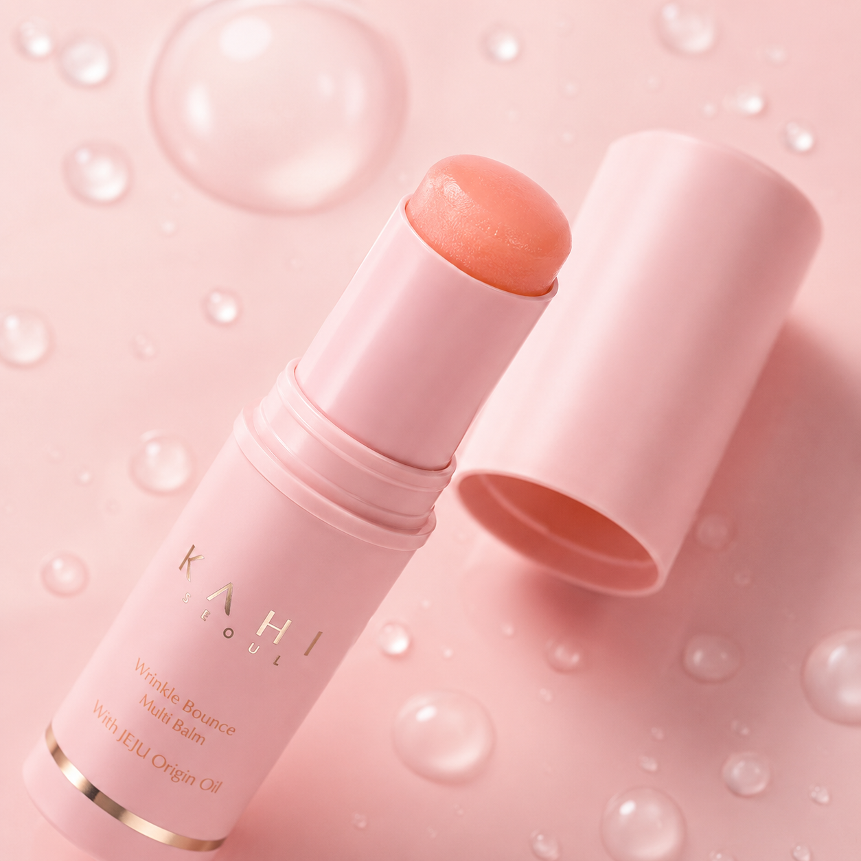 Close-up of KAHI Wrinkle Bounce Multi Balm stick texture with cap on a soft pink background.